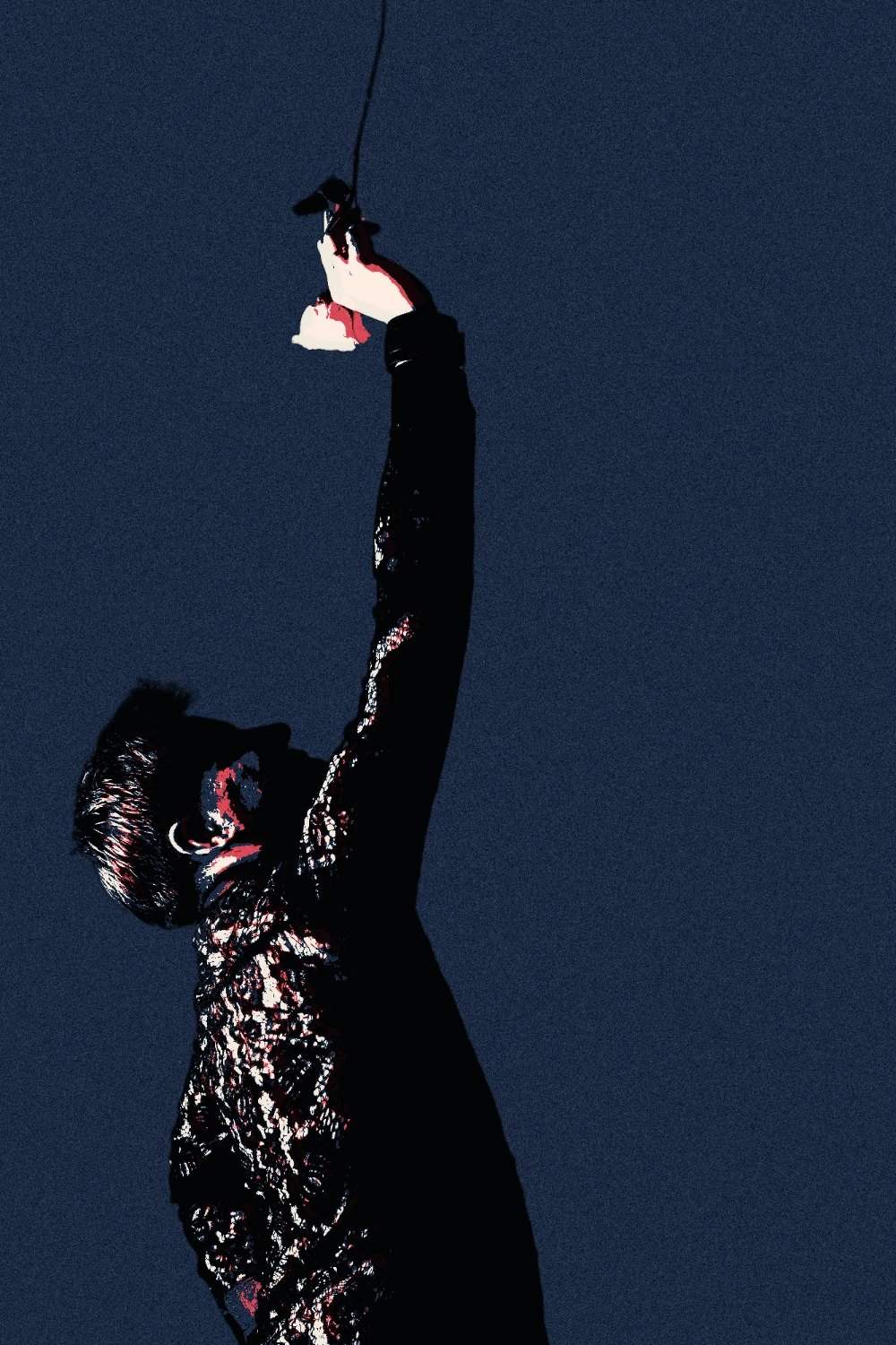 Jeffrey X Guntly in silhouette against a navy sky, one arm stretched overhead holding a single white rose